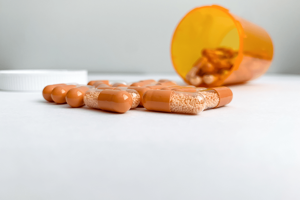 A medication bottle of Adderall sits on a table.