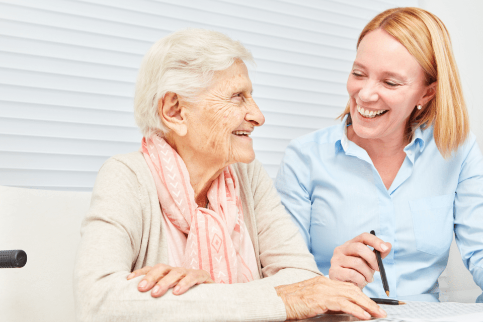 Memory care director chatting with an elderly resident.