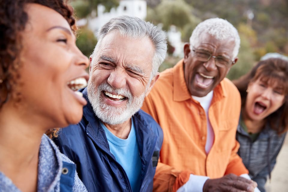 A group of seniors laugh together.